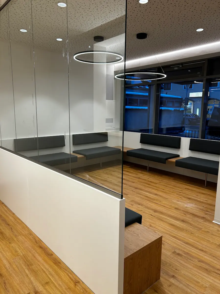 Glazed waiting area with timber interior and bespoke benches